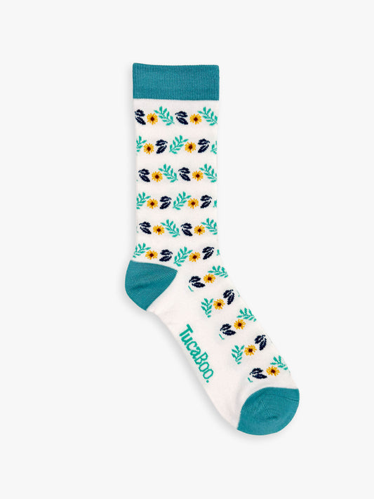 White women's floral socks with mint leaves and a teal heel