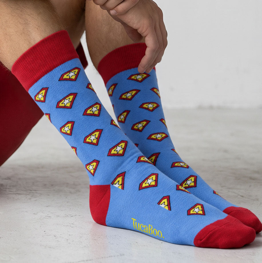 Blue aeroplane print bamboo socks with red cuffs, worn with brown suede desert boots
