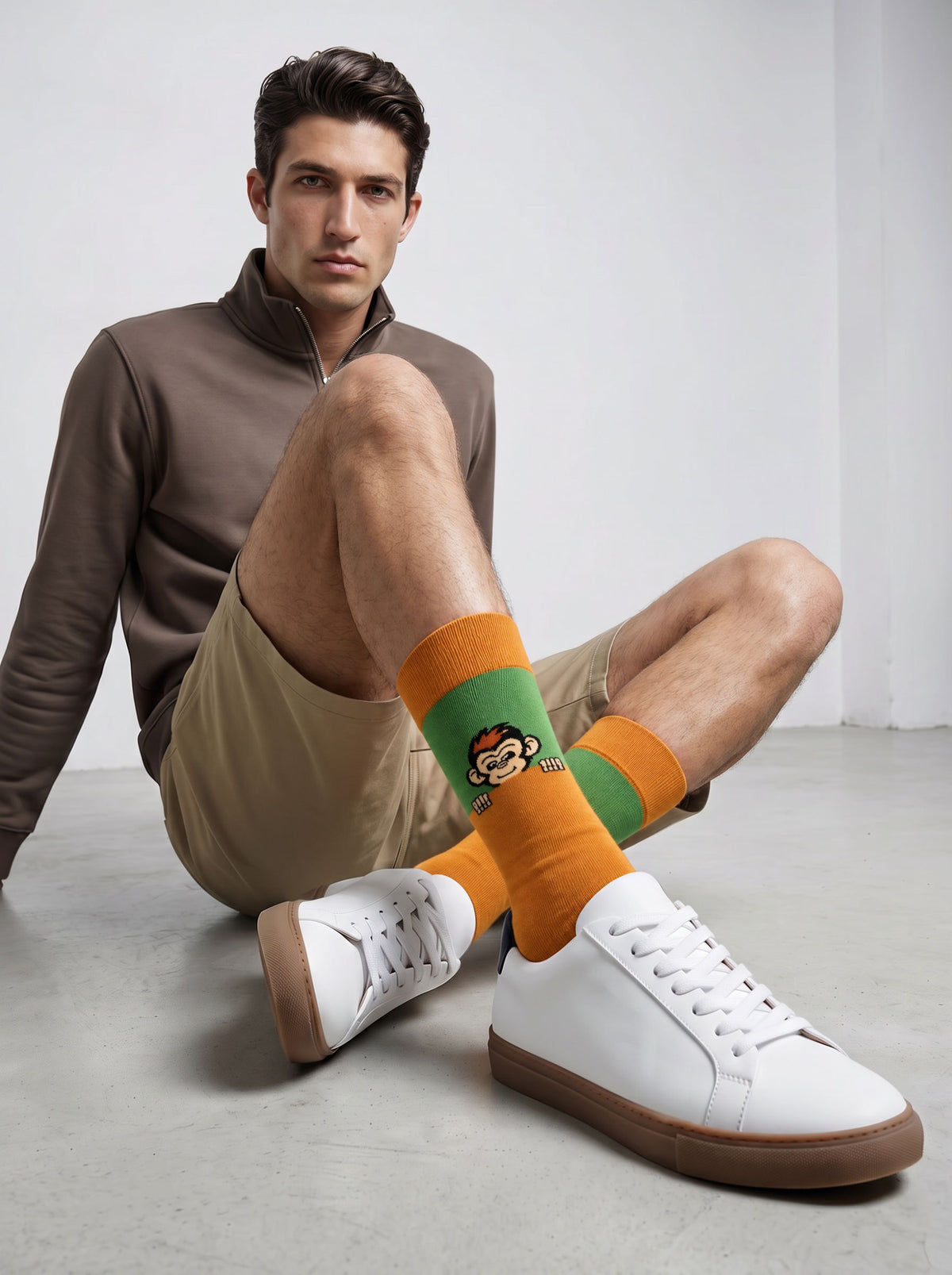 Man wearing orange Peekaboo Monkey socks with white trainers